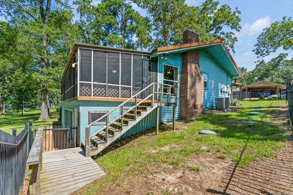 263 Crestwood Loop Avinger, TX 75630 - Photo 32 of 40 a house view with a garden space