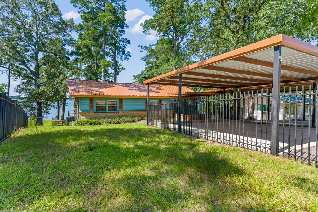 263 Crestwood Loop Avinger, TX 75630 - Photo 33 of 40 a front view of a house with a yard