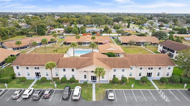 an aerial view of multiple houses with a city street