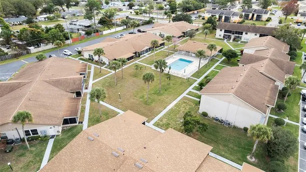 an aerial view of a house with a yard and lake view