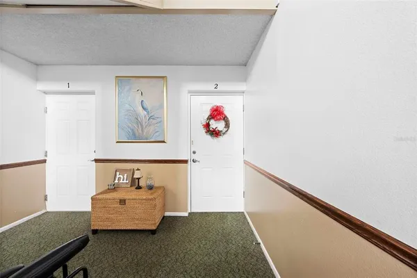 a room with furniture and wall paintings