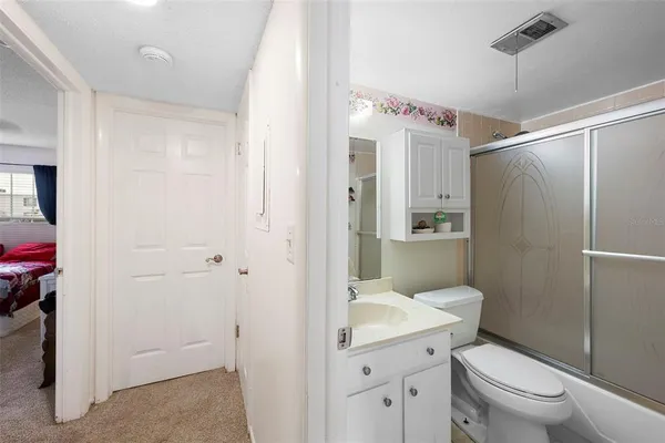 a bathroom with a toilet a sink and shower