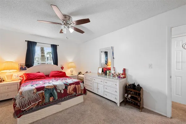 a bedroom with a bed and a ceiling fan