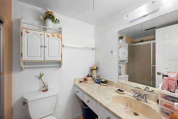 a bathroom with a sink toilet and shower