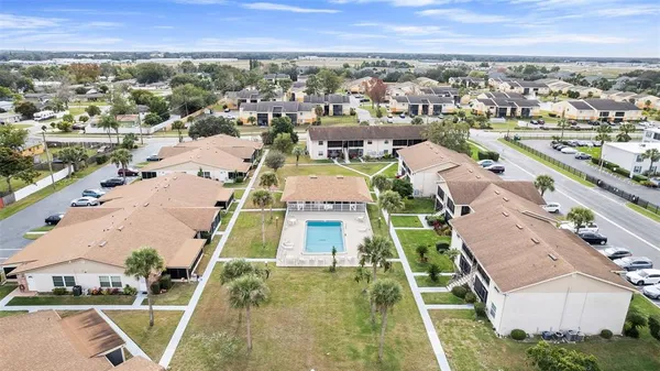 an aerial view of residential houses with outdoor space