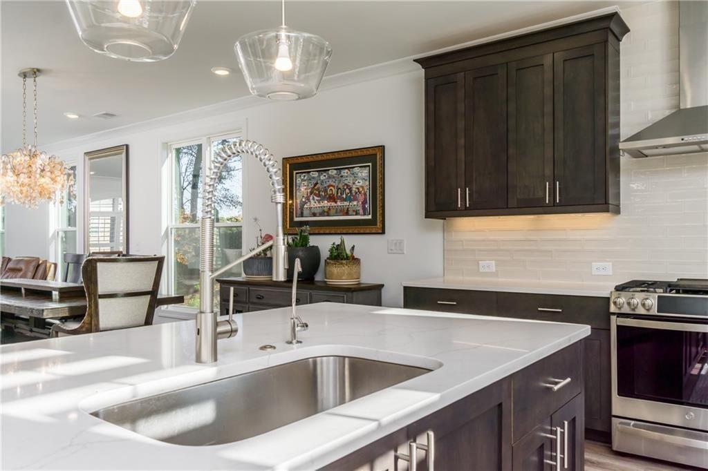 3106 Moor View Road Duluth, GA 30096 - Photo 11 of 57 a kitchen with stainless steel appliances granite countertop a sink dishwasher and cabinets with wooden floor