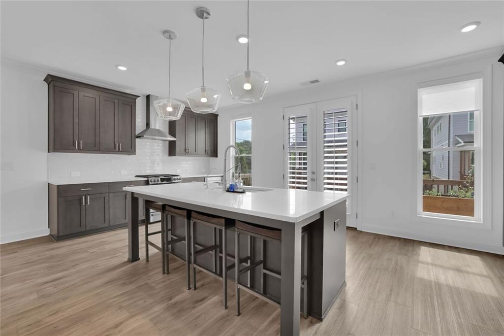 3106 Moor View Road Duluth, GA 30096 - Photo 15 of 57 a kitchen with kitchen island a wooden floor and white appliances