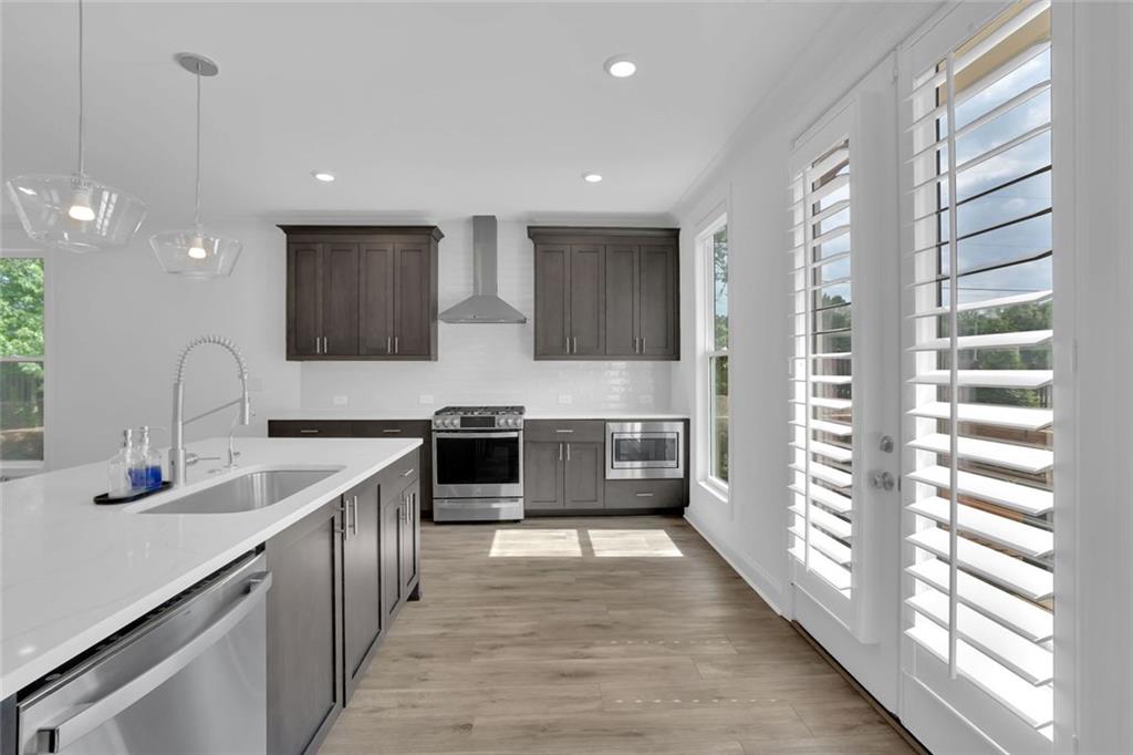 3106 Moor View Road Duluth, GA 30096 - Photo 16 of 57 a large kitchen with stainless steel appliances a lot of counter space and a sink