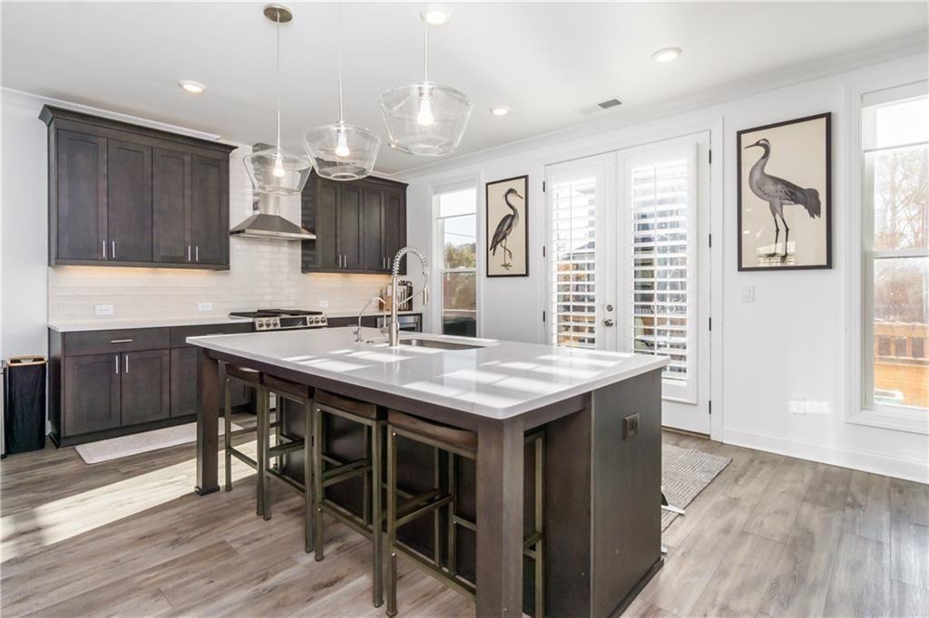 3106 Moor View Road Duluth, GA 30096 - Photo 17 of 57 a kitchen with granite countertop a sink cabinets and wooden floor