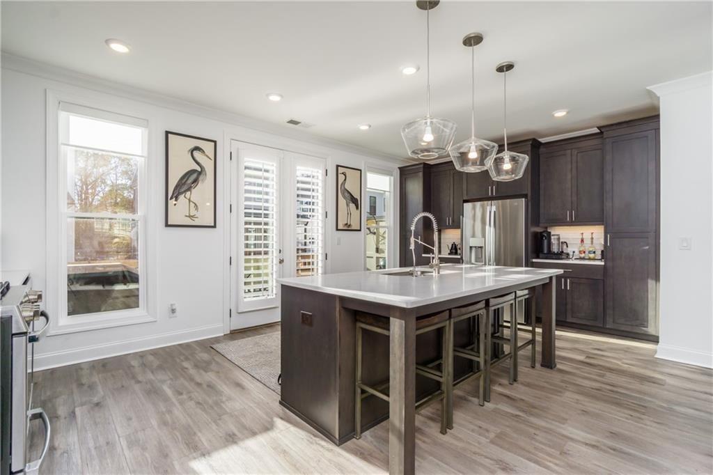 3106 Moor View Road Duluth, GA 30096 - Photo 19 of 57 an open kitchen with a table and chairs in it