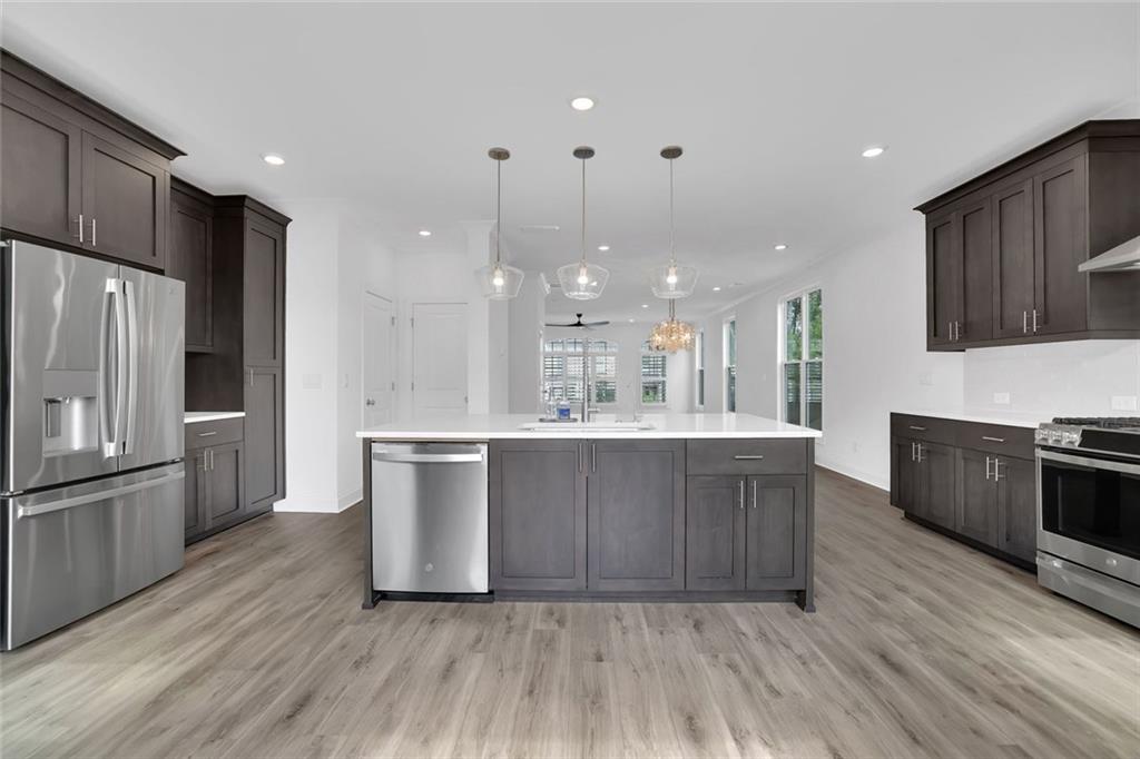3106 Moor View Road Duluth, GA 30096 - Photo 20 of 57 a large kitchen with wooden floor and stainless steel appliances