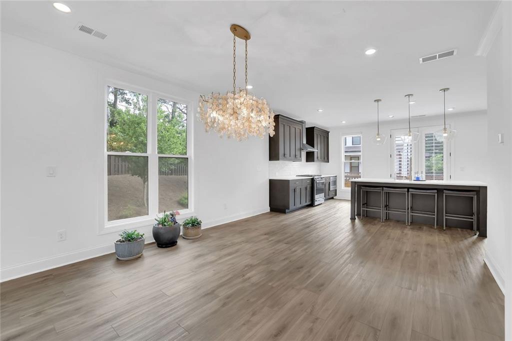 3106 Moor View Road Duluth, GA 30096 - Photo 24 of 57 a view of a room with wooden floor and a kitchen