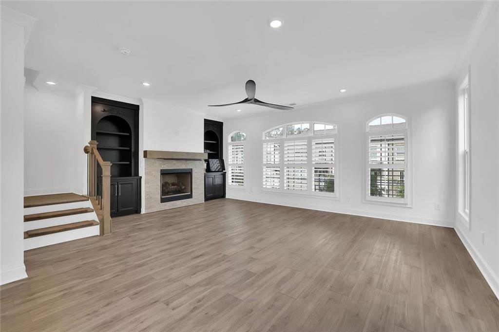 3106 Moor View Road Duluth, GA 30096 - Photo 25 of 57 an empty room with wooden floor fireplace and windows