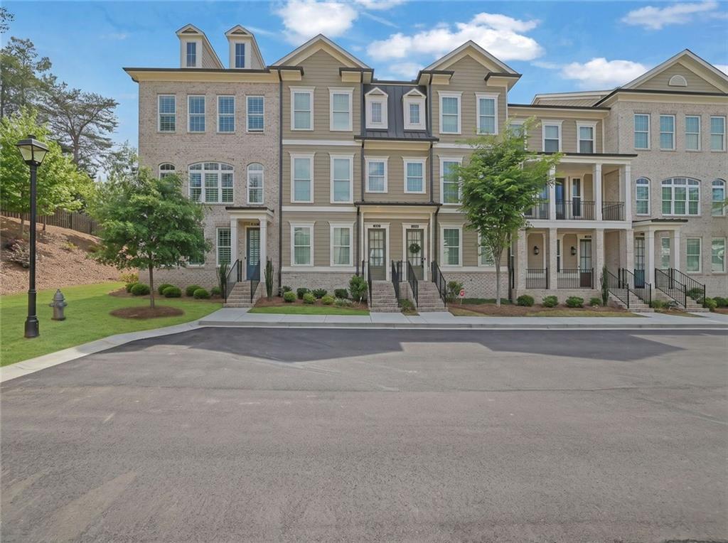 3106 Moor View Road Duluth, GA 30096 - Photo 55 of 57 a front view of a residential apartment building with a yard