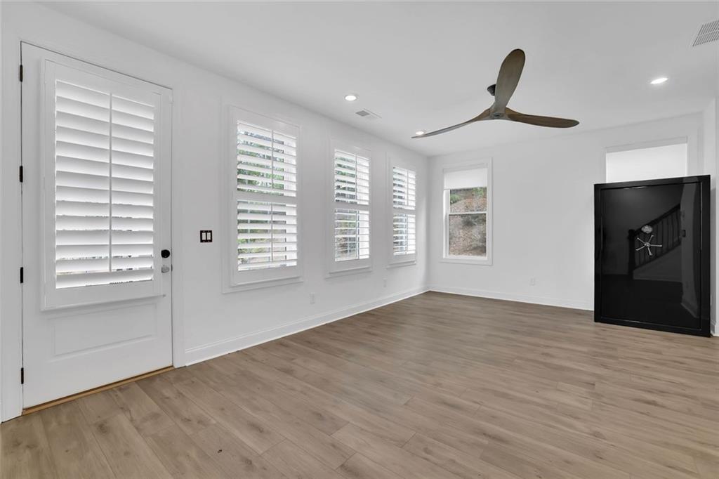3106 Moor View Road Duluth, GA 30096 - Photo 8 of 57 a view of an empty room with a window and wooden floor