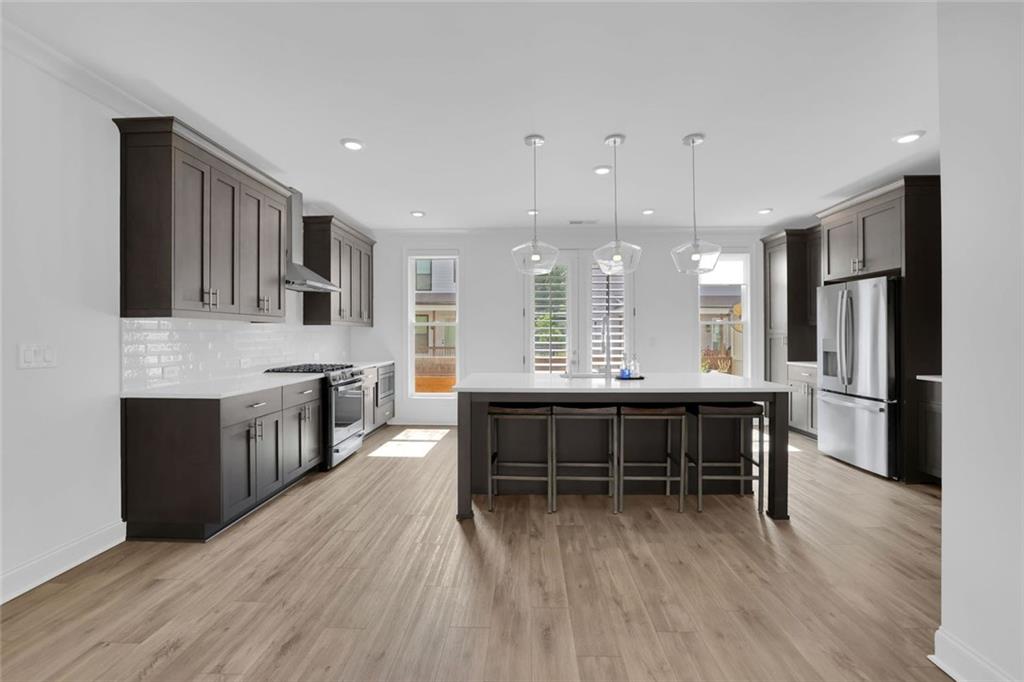 3106 Moor View Road Duluth, GA 30096 - Photo 10 of 57 a large kitchen with kitchen island a sink table and chairs