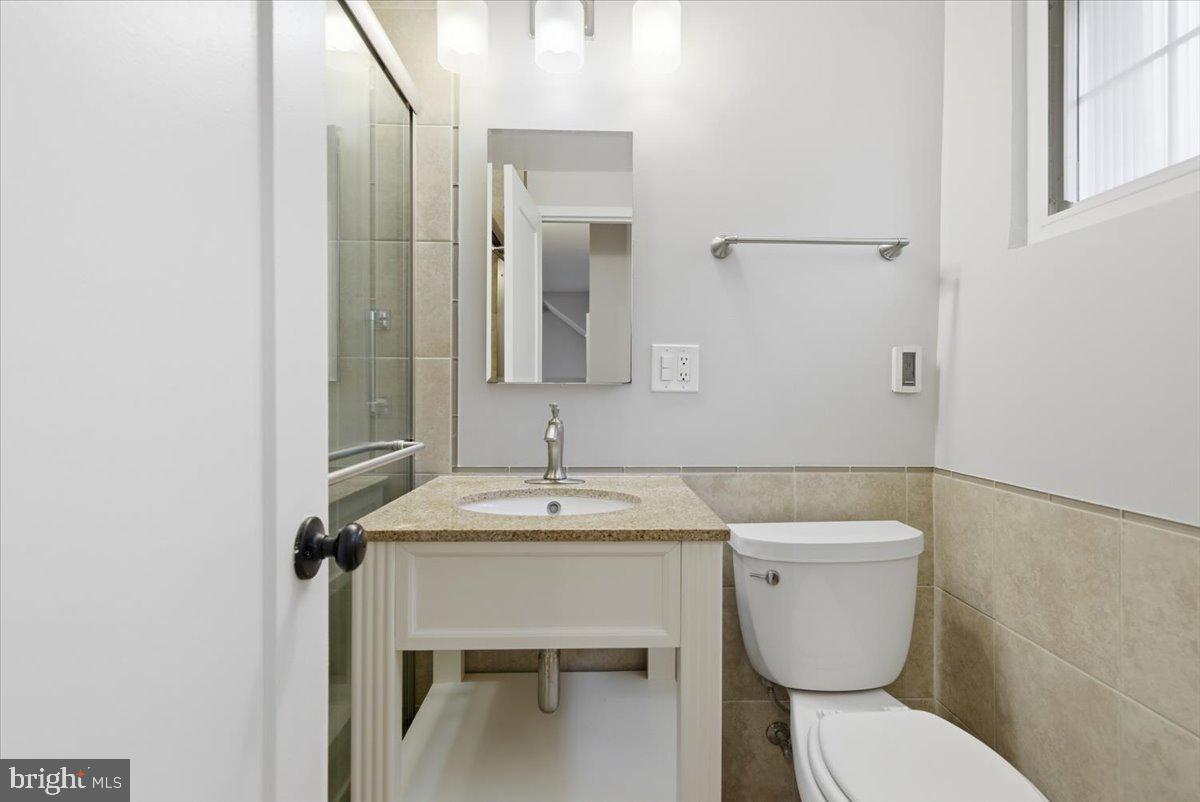 1737 Preston Road, Unit B Alexandria, VA 22302 - Photo 13 of 17 a bathroom with a toilet sink and mirror