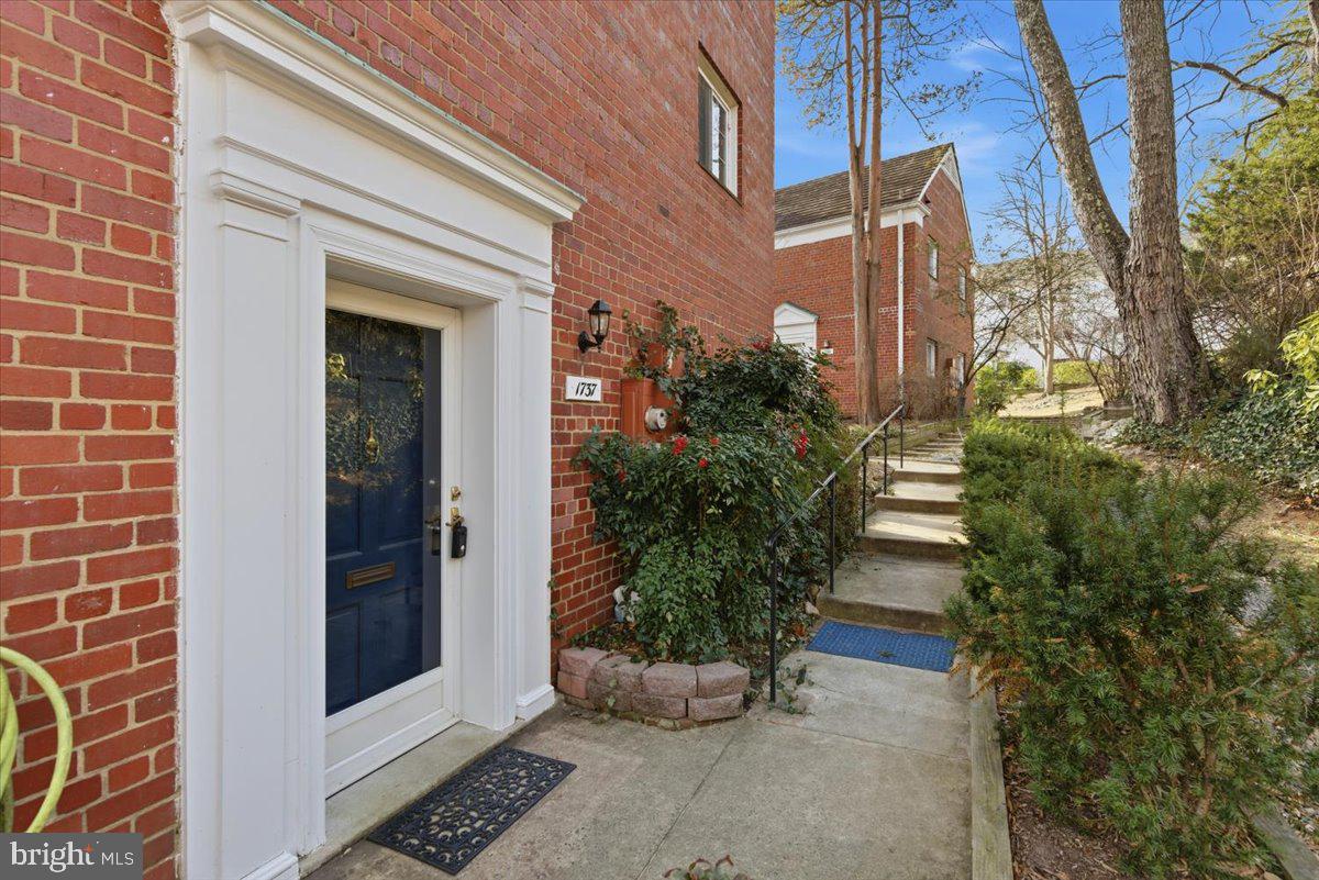 1737 Preston Road, Unit B Alexandria, VA 22302 - Photo 2 of 17 a view of a door and chair and potted plants in front of door