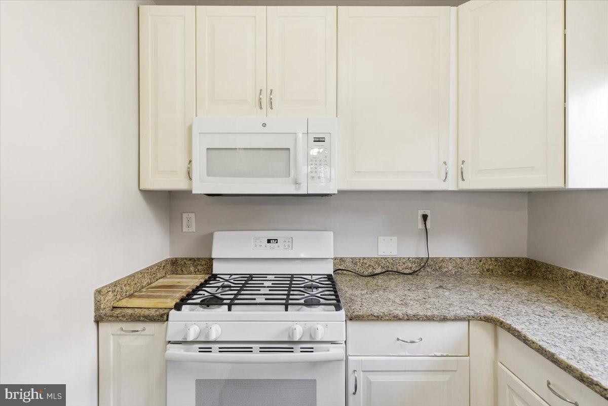1737 Preston Road, Unit B Alexandria, VA 22302 - Photo 7 of 17 a kitchen with granite countertop white cabinets and a stove