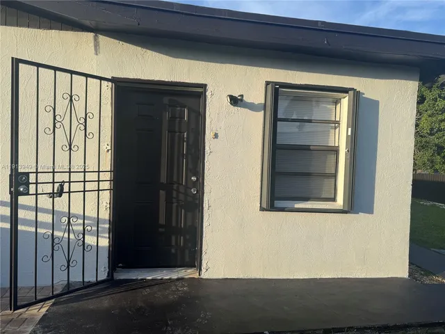 a utility room with a sink and washing machine
