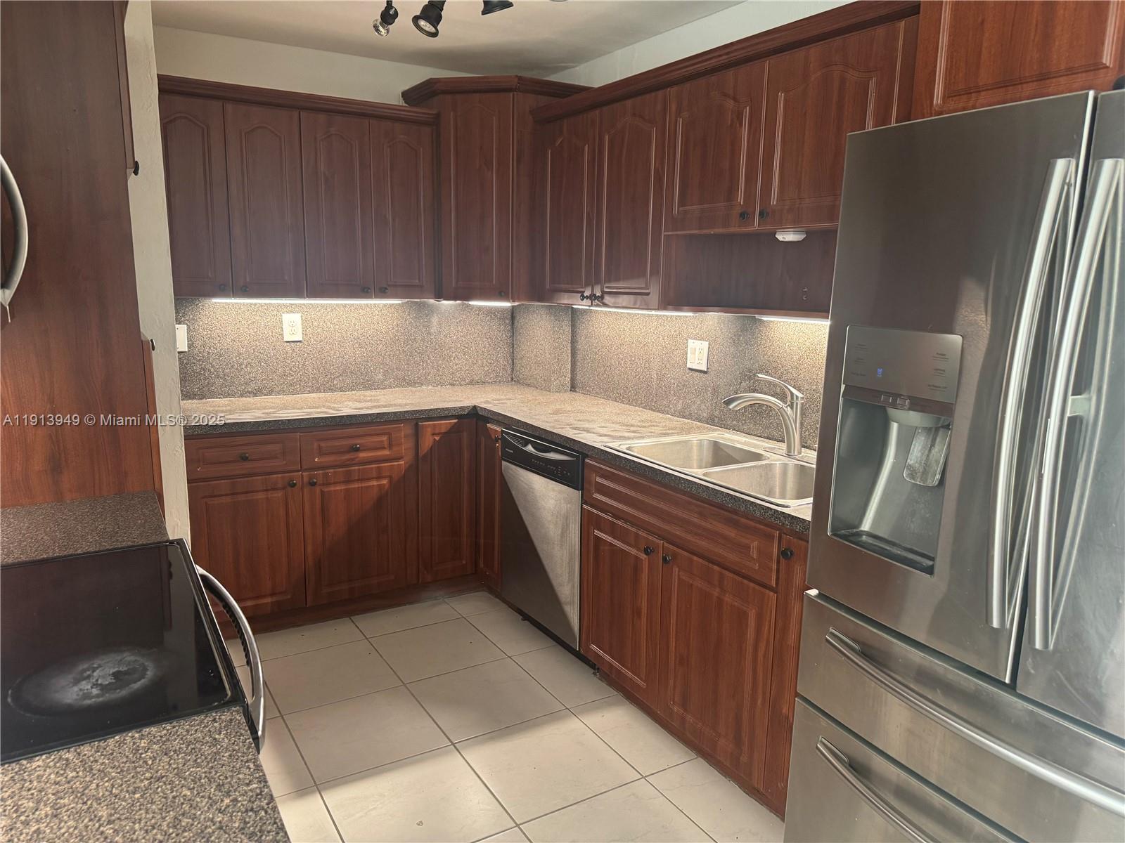 29523 Southwest 144th Court Homestead, FL 33033 - Photo 20 of 59 a kitchen with a refrigerator sink and cabinets