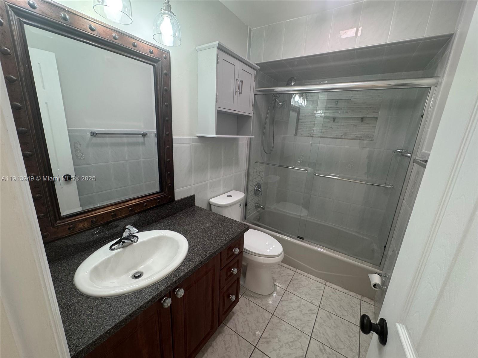 29523 Southwest 144th Court Homestead, FL 33033 - Photo 27 of 59 a bathroom with a sink toilet a mirror and shower