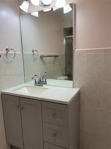 an empty room with closet and a chandelier fan