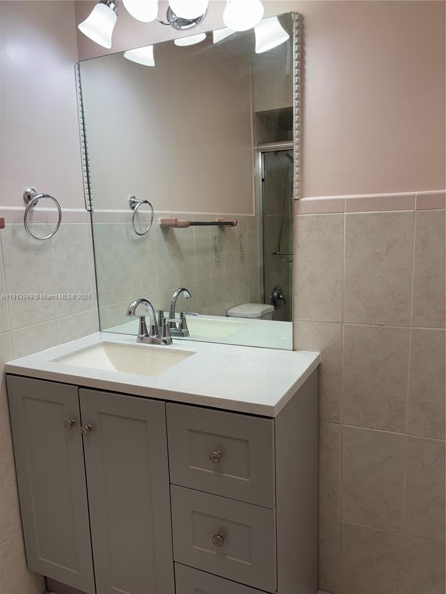 29523 Southwest 144th Court Homestead, FL 33033 - Photo 30 of 59 a bathroom with a sink and a mirror