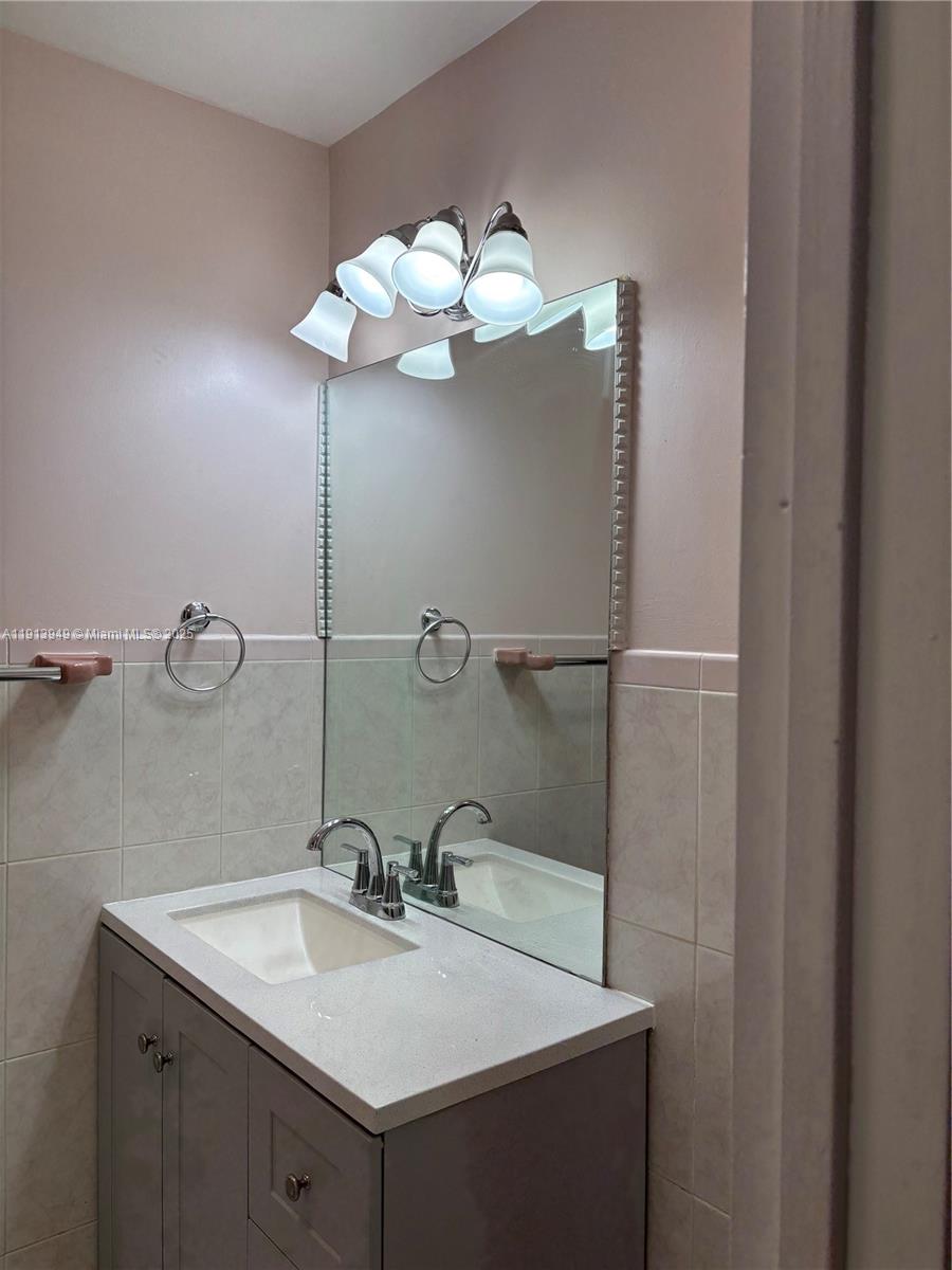 29523 Southwest 144th Court Homestead, FL 33033 - Photo 31 of 59 a bathroom with a sink vanity and mirror