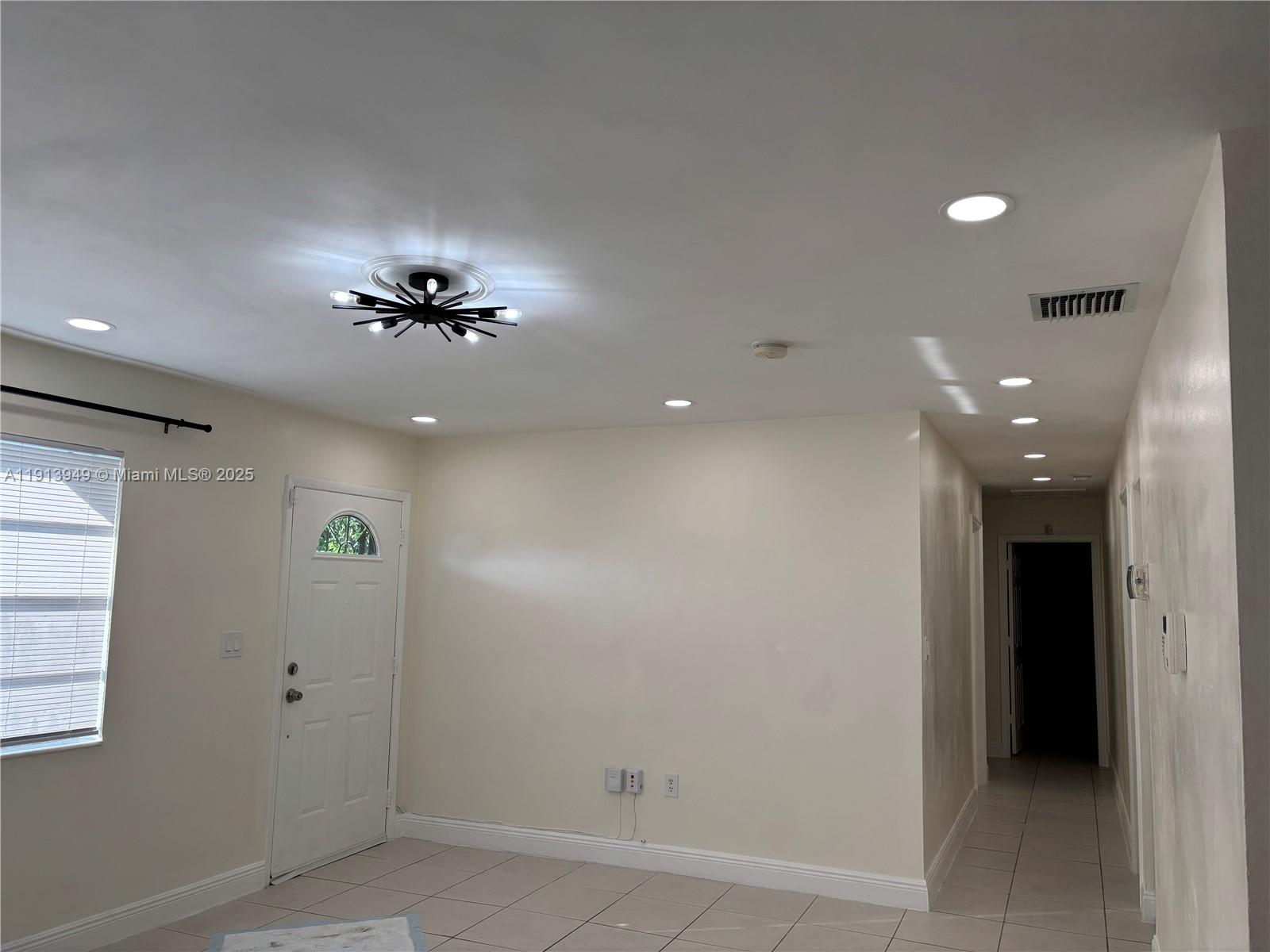 29523 Southwest 144th Court Homestead, FL 33033 - Photo 35 of 59 an empty room with closet and a chandelier fan