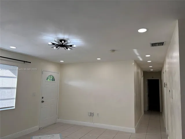 a view of an empty room with a fireplace