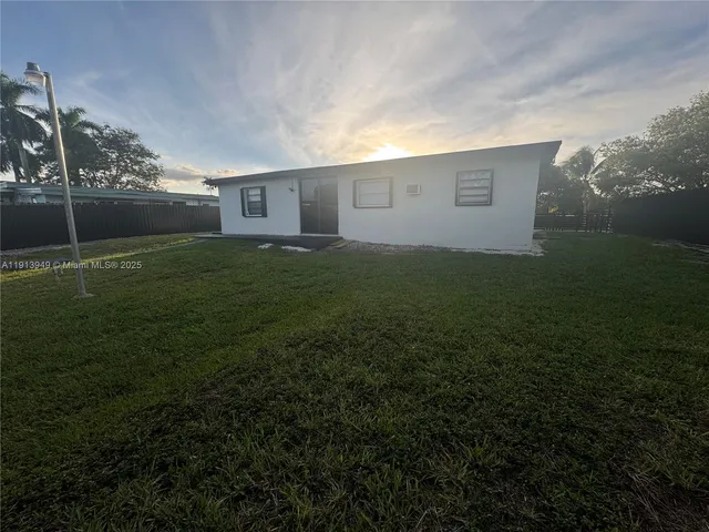 a view of a house with a backyard