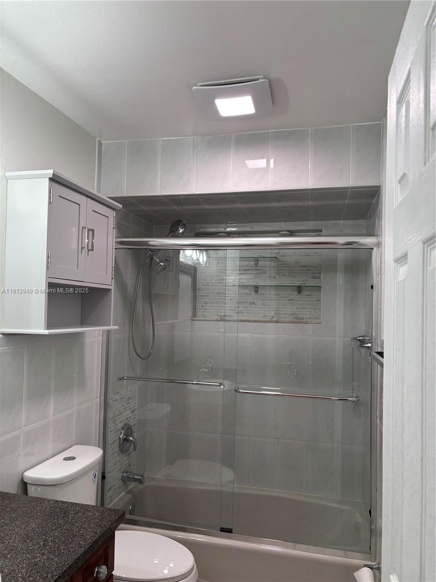 29523 Southwest 144th Court Homestead, FL 33033 - Photo 48 of 59 a bathroom with a shower a toilet and a sink