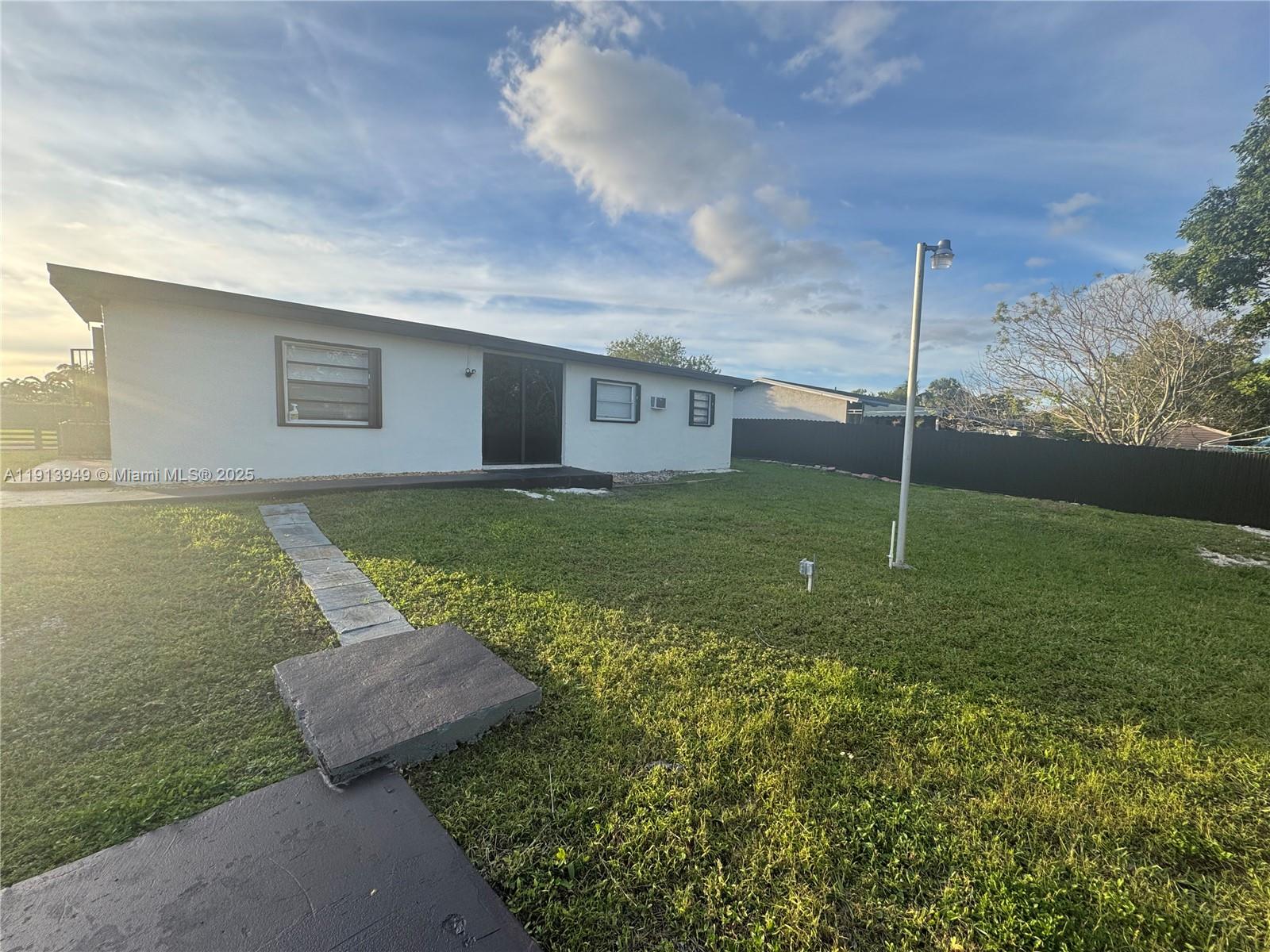 29523 Southwest 144th Court Homestead, FL 33033 - Photo 56 of 59 a view of a house with a backyard