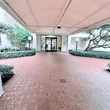 a view of a house with a yard and potted plants