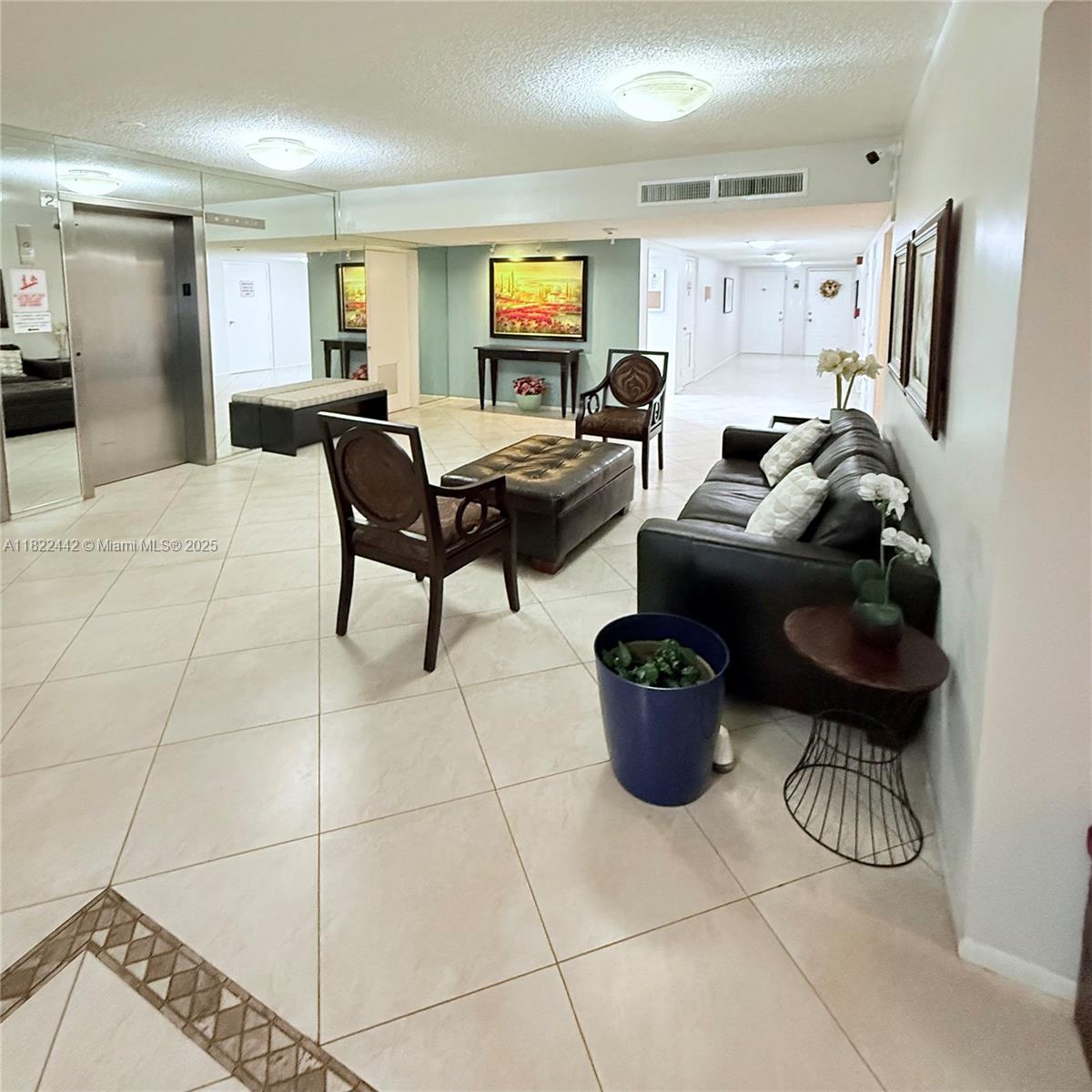 3980 Oaks Clubhouse Drive, Unit 302 Pompano Beach, FL 33069 - Photo 2 of 15 a living room with furniture and a flat screen tv