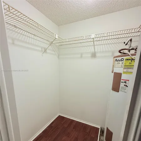 a view of a storage and utility room with racks on the wall