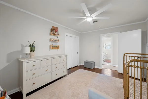 a bedroom with a bed and a dresser