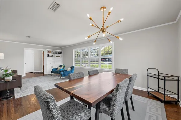 a view of a dining room with furniture window and wooden floor