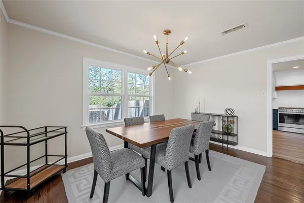 a view of a dining room with furniture window and wooden floor