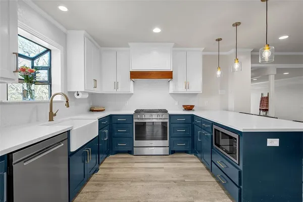 a kitchen with a stove sink and cabinets