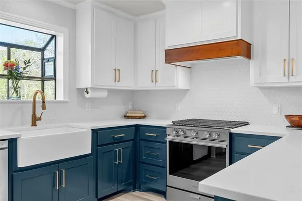 a kitchen with stainless steel appliances granite countertop a sink and cabinets