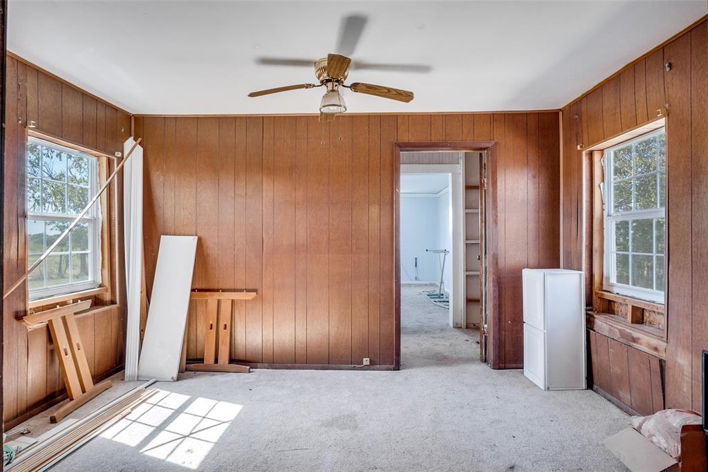 7165 County Road 1232 Godley, TX 76044 - Photo 14 of 17 a view of an empty room with a fireplace and a window
