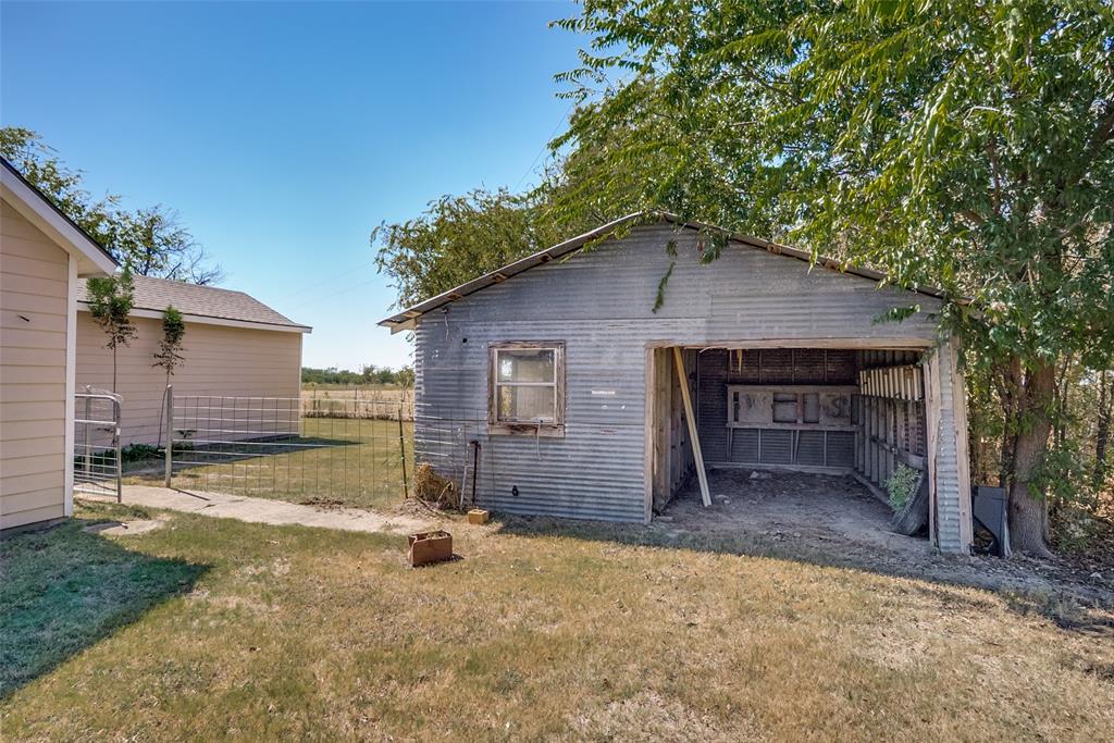 7165 County Road 1232 Godley, TX 76044 - Photo 2 of 17 a backyard of a house with table and chairs