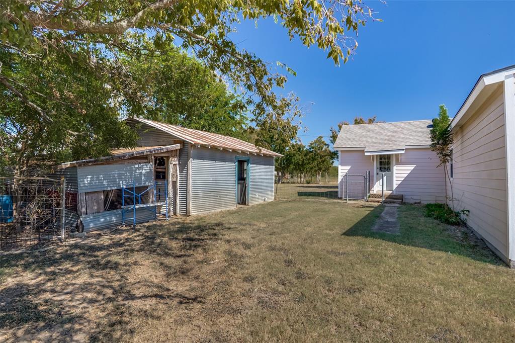 7165 County Road 1232 Godley, TX 76044 - Photo 3 of 17 a view of a house with a yard and garage