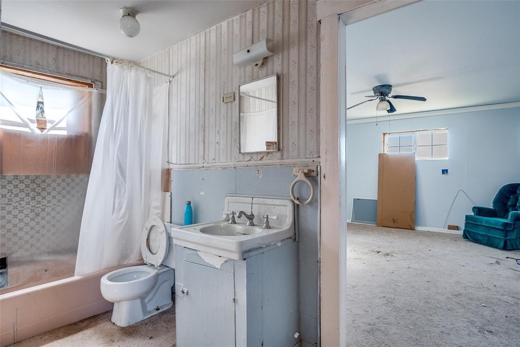 7165 County Road 1232 Godley, TX 76044 - Photo 7 of 17 a bathroom with a sink toilet and shower