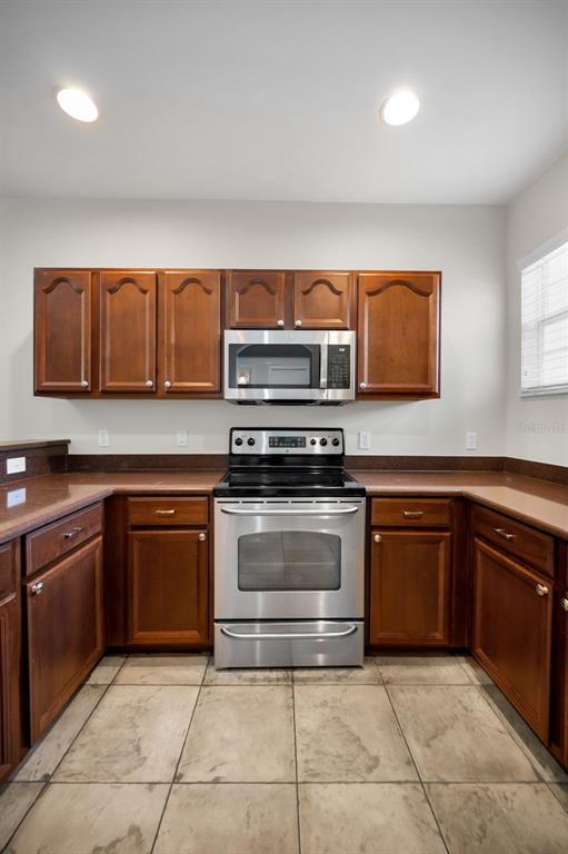5628 Sea Turtle Court New Port Richey, FL 34652 - Photo 12 of 99 a kitchen with stainless steel appliances granite countertop a sink and cabinets
