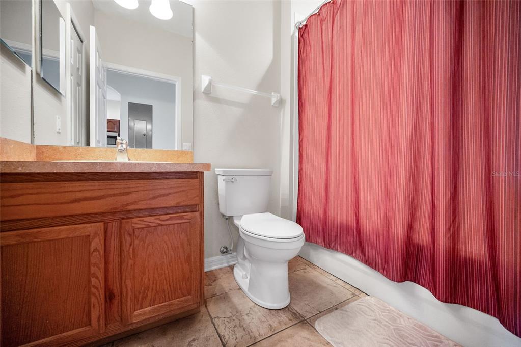 5628 Sea Turtle Court New Port Richey, FL 34652 - Photo 18 of 99 a bathroom with a toilet a sink and curtain