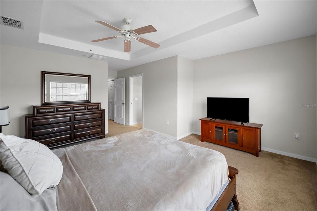 5628 Sea Turtle Court New Port Richey, FL 34652 - Photo 22 of 99 a bedroom with a bed and a flat screen tv