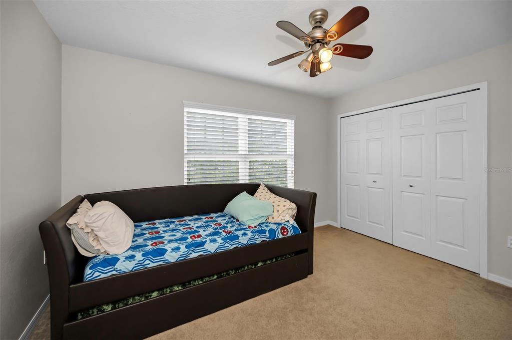 5628 Sea Turtle Court New Port Richey, FL 34652 - Photo 27 of 99 a bedroom with a bed and a window